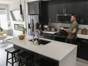 Agnes Garcia and Paulo Cruz in the kitchen of their detached Nixon laned home by Morrison Homes.