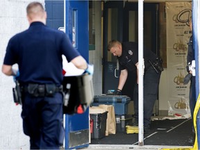 Police work at the scene of a multiple shooting at the Duggan Community Hall, 3728 106 St., in Edmonton Monday Aug. 30, 2021. One person is dead and six others were injured following an early morning shooting Sunday at the community hall.