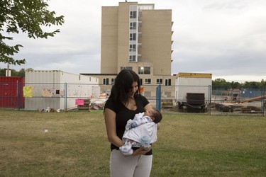 Three week-old Micah Mindus-Morin is held by his mother Claudine Mindus during a protest on the grounds of the former Charles Camsell Indian Hospital, in Edmonton Monday Aug. 9, 2021. The protesters hope to bring awareness to the discovery of over 5,000 unmarked graves at Canada's former residential school sites. Over nearly 50 days the nightly protest has hosted healers, drummers, speakers, survivors and singers. Part of the hospital site was recently searched for unmarked graves and future searches are planned.