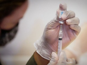 A health-care worker prepares a dose of the Johnson & Johnson vaccine for the coronavirus disease (COVID-19) during the opening of the MTA's public vaccination program at Grand Central Terminal train station in Manhattan in New York City, New York, U.S., May 12, 2021.