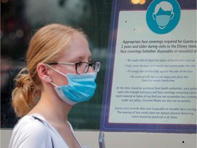 A woman wears a mask against the coronavirus disease (COVID-19), following the CDC recommendation that fully vaccinated Americans wear masks as the highly transmissible Delta variant has led to a surge in infections, as she enters the Disney Store in Times Square in New York City, New York, U.S., July 27, 2021. REUTERS/Brendan McDermid