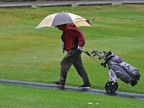 A dedicated golfer battles the elements at the Victoria Golf Course as the long awaited rain for this summer finally arrived, we do need the rain in Edmonton, August 23, 2021. Ed Kaiser/Postmedia