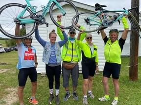 Meghan Harris, second from left, celebrates after leading her Mighty Meghan cycling team around the 58.5-km bike ride around Pigeon Lake on Saturday, Sept. 11, 2021, in support of the Glenrose Rehabilitation Hospital.