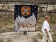 Linday Sutton walks in front of the quilt that started it all in the Badlands. Miruna Dragan photo.