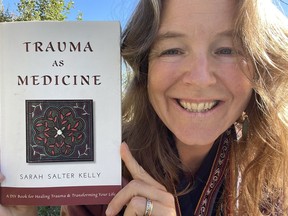 Sarah Salter-Kelly with her first published book, Trauma as Medicine.