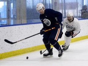 Adam Cracknell (27) battles Ryan Stanton (5) during an Edmonton Oilers training camp scrimmage, in Edmonton Thursday Jan. 7, 2021.