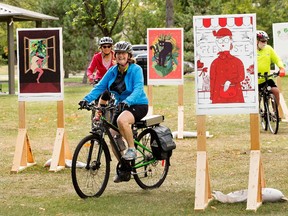 Cyclists ride through The Plant Show illustrative art exhibition in Borden Park, in Edmonton Tuesday Sept. 7, 2021. The show runs until Sept. 20. Photo by David Bloom