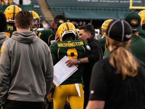 Edmonton Elks’ Trumaine Washington (8) is congratulated by head coach and offensive co-ordinator Jaime Elizondo after an interception return for a touchdown against the Calgary Stampeders at Commonwealth Stadium in Edmonton on Saturday, Sept. 11, 2021.
