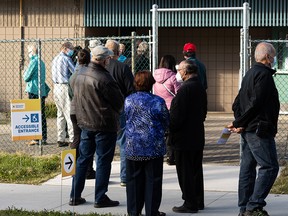 People wait in a long line to cast a ballot at the first day of advance polls at Jasper Place Annex for the 2021 civic election in Edmonton, on Monday, Oct. 4, 2021. Photo by Ian Kucerak