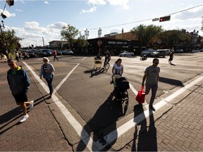Pedestrians cross a new scamble intersection at Gateway Boulevard and Whyte Avenue in Edmonton, on Friday, Sept. 3, 2021. The intersections stop all traffic to let pedestrians cross safety and then allow vehicles through in alternating directions, while making turning right on a red light illegal. Photo by Ian Kucerak