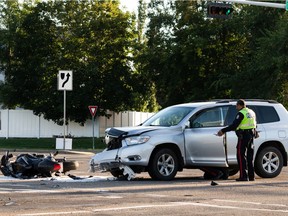 Edmonton Police Service officers investigate a multi-vehicle crash involving a motorcycle at 153 Avenue and 82 Street in Edmonton, on Friday, Sept. 3, 2021. The intersection was initially closed for the investigation.