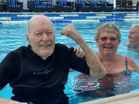 Flexing his muscles to show just how fit he is at age 102 is Doug MacDougall, who participates  thrice weekly at aquafit swim exercises at the Royal Glenora Club. He is pictured with his daughter Mary Greenwood, 71.