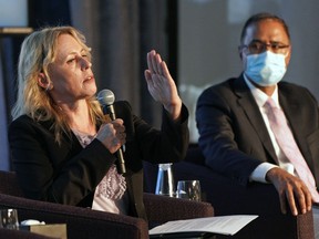 Edmonton mayoralty candidate Kim Krushell, left, speaks at a mayoral forum held at the Westin Hotel in Edmonton on Thursday Sept. 9, 2021. Candidates Amarjeet Sohi, right, Michael Oshry and Cheryll Watson also participated. A municipal election will be held in Edmonton on Oct. 18, 2021.