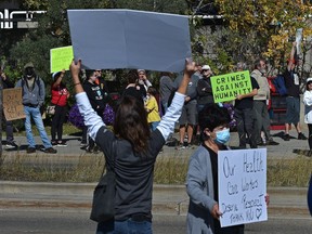 Over 100 people showed up for a national day of protest against mandatory vaccination for health care workers and about 30 opposed gathered across the street outside the Royal Alexandra Hospital, organized by the Canadian Frontline Nurses, in Edmonton, Sept. 13, 2021.