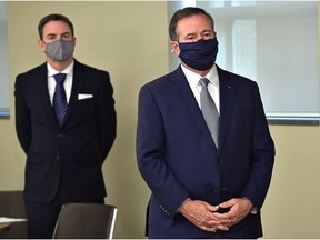 Premier Jason Kenney standing in front of Jason Copping the newly appointed Minister of Health during a news conference in Edmonton, September 21, 2021. Ed Kaiser/Postmedia