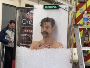 Edmonton firefighter Wes Bauman on his way to setting a new ice-bath record of two hours and 20 minutes at Firehall 2 in February last year.