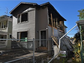 Fire investigators are investigating a suspicious early morning fire at a house under construction where the whole second floor wall fell onto the neighbour's yard. A firefighter was injured while fighting the blaze on 94 Street near 114 Avenue in Edmonton on Monday, Sept. 27, 2021.