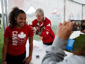 Fancy Bermudez, left, has her shirt signed by Jen Kish during a meet and greet at the Rockers Athletic Club in Edmonton on Thursday, Aug. 25, 2016.