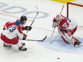 Canada's Connor Zary (9) reaches for the puck against the Czech Republic's Simon Kubicek (23) and goalie Nick Malik (30) in the IIHF world junior championship quarter-final on Jan. 2, 2021 in Edmonton.