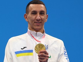 Tokyo 2020 Paralympic gold medalist Denys Dubrov of Ukraine celebrates on the podium, August 28, 2021.