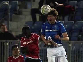 FC Edmonton's Easton Ongaro (right) and Calvalry FC's Victor Loturi (left) battle for the ball during Canadian Premier League soccer game action in Edmonton on Wednesday September 29, 2021.