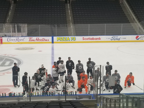Coach Dave Tippett (front right) has the full attention of his crew at the Edmonton Oilers training camp on Thursday, Sept. 23, 2021 in Edmonton.