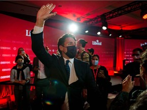 Canadian Prime Minister Justin Trudeau waves as he leaves leaves the Fairmount Queen Elizabeth Hotel after delivering his victory speech in Montreal, Quebec, early on September 21, 2021.