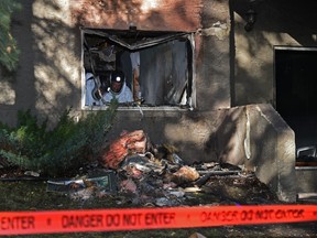 Fire investigators on the scene of an overnight fire that seems to have started on the main floor of Sandlewood Place apartments 6504 129 Ave. in Edmonton, September 23, 2021.