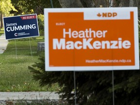 Edmonton Centre Federal election signs for the NDP's Heather MacKenzie and the Conservatives' James Cumming are visible in front of homes, in Edmonton Monday Sept. 13, 2021. Photo by David Bloom