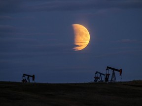 The moon rises over pumpjacks near Arrowwood, east of Calgary.