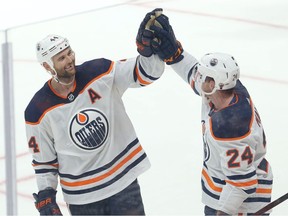 Edmonton Oilers forward Zack Kassian, left, congratulates forward Brad Malone on his goal against the Jets in Winnipeg on Wednesday, Sept. 29, 2021.