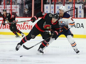Tim Stützle (18) of the Ottawa Senators battles for the puck against Kyle Turris (8) of the Edmonton Oilers at Canadian Tire Centre on April 7, 2021, in Ottawa.