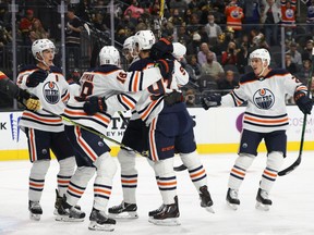 The Edmonton Oilers celebrate a first-period power-play goal by Zach Hyman #18 against the Vegas Golden Knights during their game at T-Mobile Arena on October 22, 2021 in Las Vegas, Nevada.