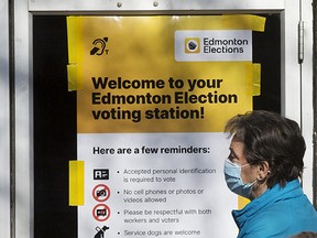 Edmontonians wait for the the advance polling station at the Hazeldean Community League, Monday, Oct. 4, 2021. As well as the municipal election, residents across Alberta will also be voting on referendum questions regarding equalization and year-round daylight saving time.