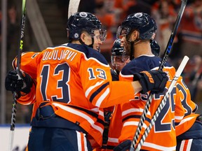 Edmonton Oilers forward Jesse Puljujarvi (13) celebrates a goal with teammates against Vancouver Canucks goaltender Thatcher Demko (35) at Rogers Place in Edmonton on Wednesday, Oct. 13, 2021.