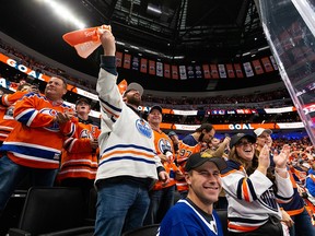 Hockey fans cheer Edmonton Oilers’ Jesse Puljujarvi (13) goal on Vancouver Canucks’ goaltender Thatcher Demko (35) during first period NHL action at Rogers Place in Edmonton, on Oct. 13, 2021.