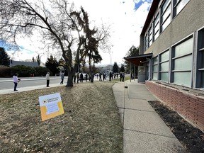 Voters line up to advance vote in the municipal election outside of Bellevue Community League at 7308 112 Ave NW in Edmonton, on Wednesday, Oct. 13, 2021. Advance voting turnout is up according to the City of Edmonton. Photo by Ian Kucerak