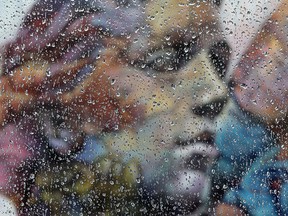 Rain drops are visible on a car window in front of a mural by Spanish graffiti artists PichiAvo, near 106 Street and 103 Avenue, in Edmonton Saturday Oct. 23, 2021. Photo by David Bloom