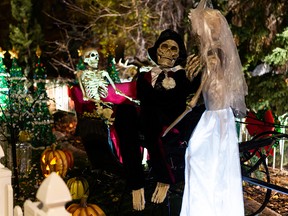 A skeleton bride and her groom are seen at a mixed spooky Halloween and Christmas display at a home at 97 Street and 144 Avenue in Edmonton, on Tuesday, Oct. 26, 2021. Photo by Ian Kucerak