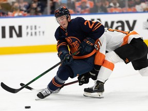 Edmonton Oilers’ Tyson Barrie (22) downs Philadelphia Flyers’ Travis Konecny (11) at Rogers Place in Edmonton on Wednesday, Oct. 27, 2021.