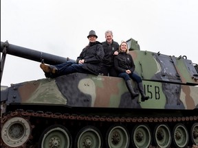 Sean Rayner, the fourth generation company president of the VETS Group, left, his father David Rayner, the third generation president. and daughter and marketer Erin Rayner, a member of the fourth generation in the company, on a M109 Howitzer at Hole 15 of the Edmonton Garrison Memorial Golf and Curling Club. Photo Supplied/ Moments in Digital Photography