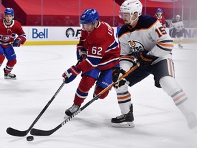 Montreal Canadiens forward Artturi Lehkonen (62) and Edmonton Oilers forward Josh Archibald (15) battle for the puck during the first period at the Bell Centre.