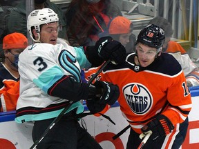 Edmonton Oilers winger Zach Hyman (right) collides with Seattle Kraken defenceman Will Borgen (left) during pre-season NHL hockey game action in Edmonton on Sept. 28, 2021.