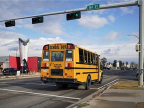 A school bus drives past the intersection at 167 Street and 100 Avenue on Monday October 25, 2021, where a 14-year-old girl was seriously injured when she was struck by a school bus in the morning.