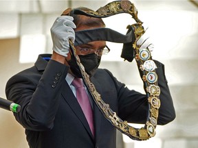 Edmonton Mayor Amarjeet Sohi puts on the Mayor's Chain of Office after being sworn in at Edmonton City Hall on Tuesday October 26, 2021.