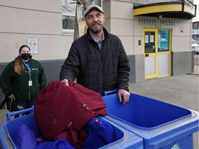Pastor Quinn Strikwerda (Community of Emmanuel Church) makes a winter clothing donation at the Bissel Center in Edmonton on Wednesday October 27, 2021. The Bissel Center (10530-96 Street) and Bent Arrow Traditional Healing Society (11648-85 Street) are accepting donations of winter clothing until Thursday October 28, 2021. Bissel Center employee Nadine Hamilton (background) was assisting in taking the donations.