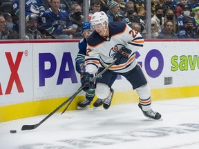 Vancouver Canucks forward Conor Garland (8) defends against Edmonton Oilers defenseman Tyson Barrie (22) in the first period at Rogers Arena on Oct. 30, 2021.