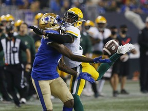 Winnipeg Blue Bombers' Darvin Adams (1) can’t get his hands on the ball as Edmonton Elks cornerback Jonathan Rose (0) defends in Winnipeg on Friday, October 8, 2021.