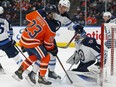 Winnipeg Jets goaltender Eric Comrie (1) makes a save on Edmonton Oilers forward Seth Griffith (23) at Rogers Place on Saturday, Oct. 2, 2021.