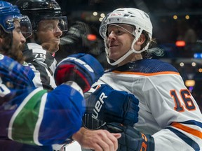 Edmonton Oilers forward Tyler Benson (16) gets into a scrum after the whistle with Vancouver Canucks forward Conor Garland (8) at Rogers Arena on Oct 9, 2021.